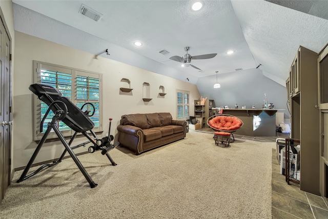 carpeted living room with a textured ceiling, ceiling fan, and vaulted ceiling