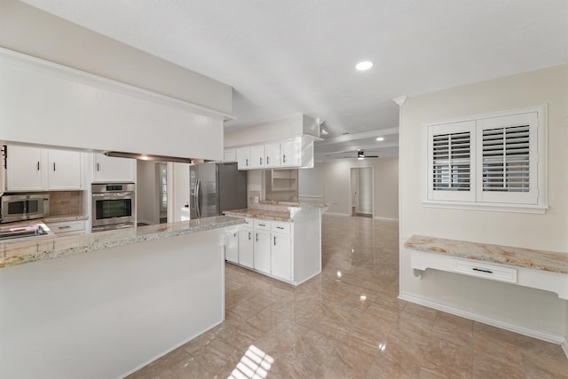 kitchen with ceiling fan, light stone counters, white cabinets, and appliances with stainless steel finishes