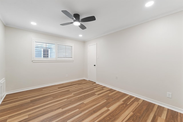 unfurnished room featuring hardwood / wood-style flooring, ceiling fan, and crown molding