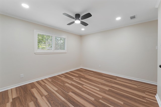 empty room with hardwood / wood-style floors and ceiling fan