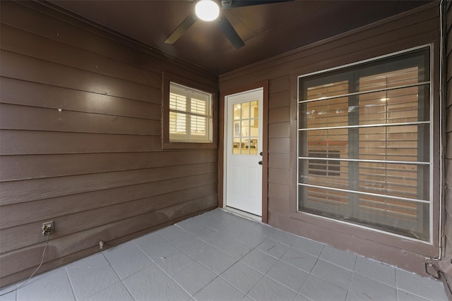 view of exterior entry featuring ceiling fan