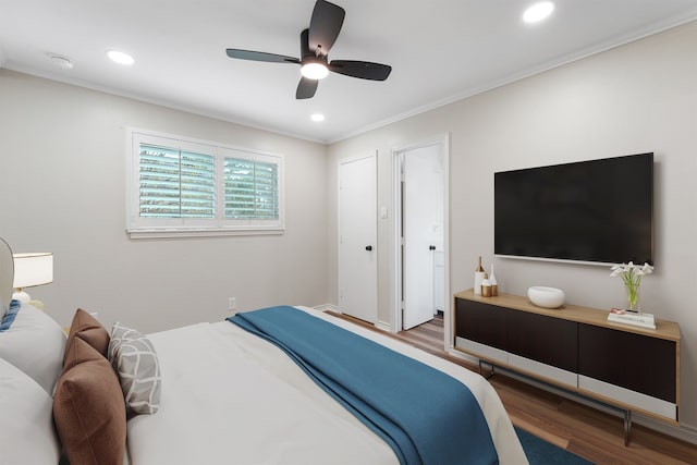 bedroom with wood-type flooring, ceiling fan, and crown molding