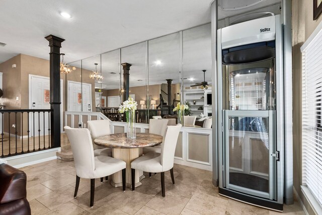 dining space featuring ceiling fan with notable chandelier and beverage cooler