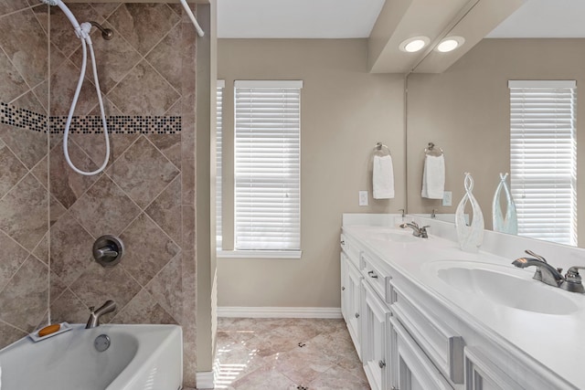 bathroom with vanity, tiled shower / bath combo, and tile patterned flooring