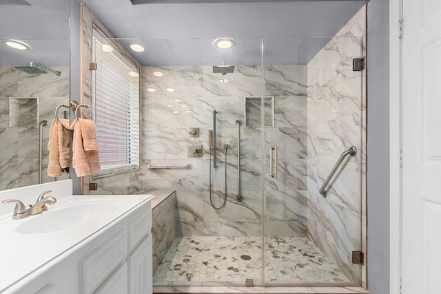 bathroom featuring walk in shower and vanity