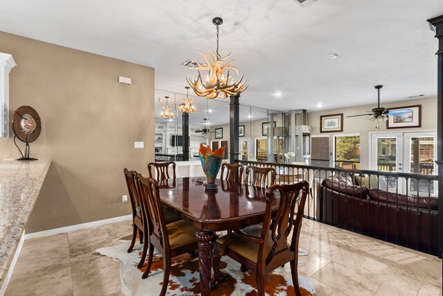 dining area featuring ceiling fan with notable chandelier