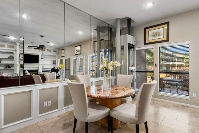 dining area with light tile patterned flooring, ceiling fan, and built in shelves