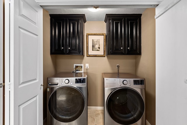 washroom with tile patterned floors and washing machine and clothes dryer