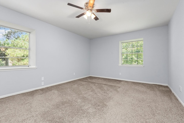 empty room featuring carpet flooring and ceiling fan