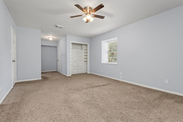 unfurnished bedroom featuring ceiling fan, carpet flooring, and a closet