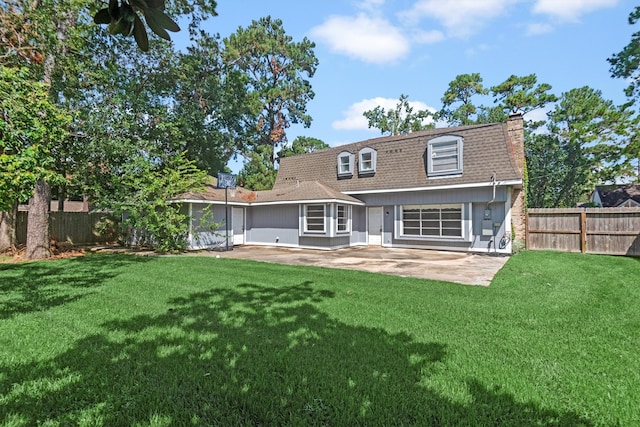 back of property featuring a patio area and a yard