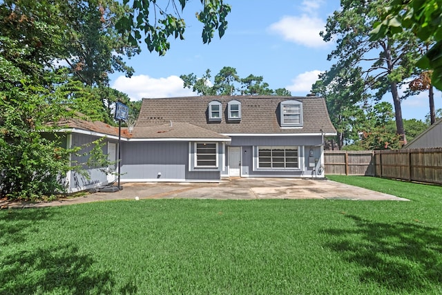 back of house with a patio area and a yard