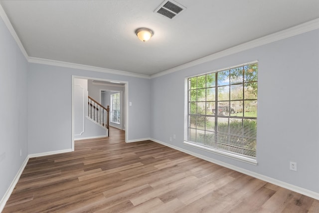 spare room with hardwood / wood-style flooring and ornamental molding