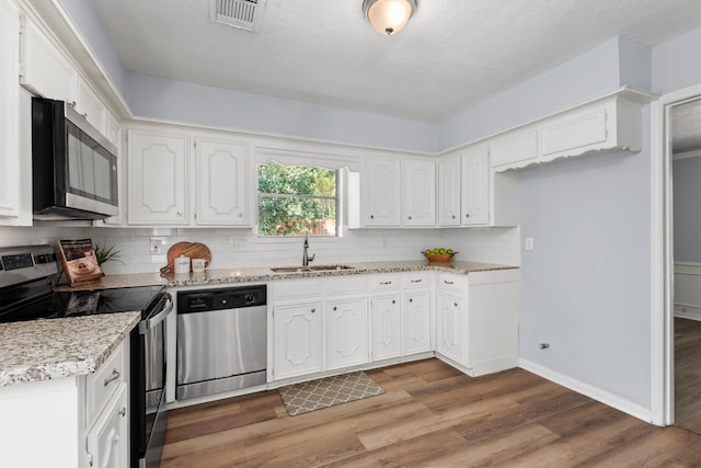 kitchen featuring white cabinetry, sink, and appliances with stainless steel finishes