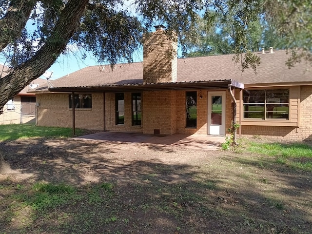 back of property with a patio