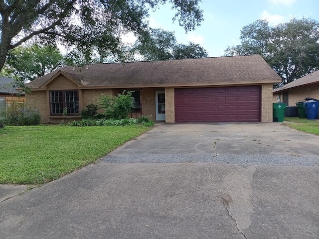 single story home featuring a front lawn and a garage