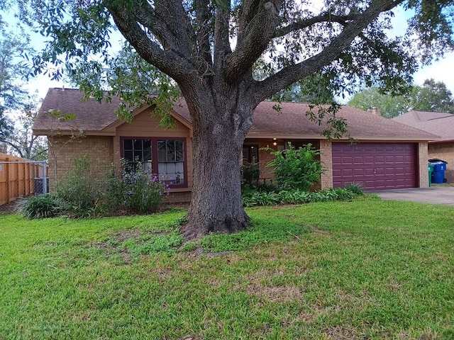 view of front of house with a garage and a front lawn