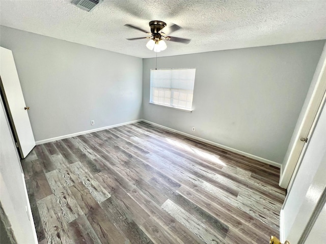 empty room featuring hardwood / wood-style flooring, ceiling fan, and a textured ceiling