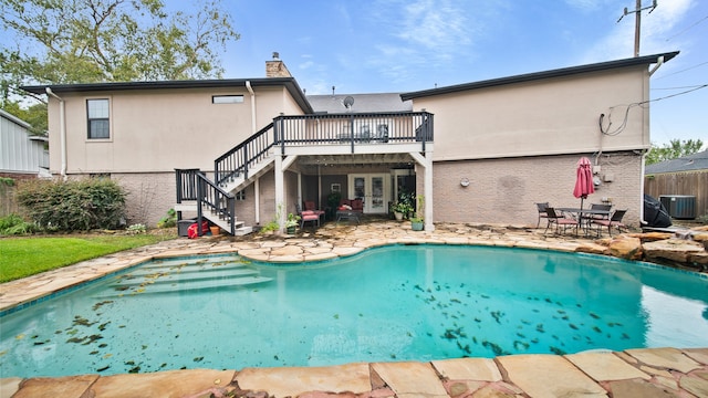 rear view of house featuring central AC, a pool side deck, and a patio area