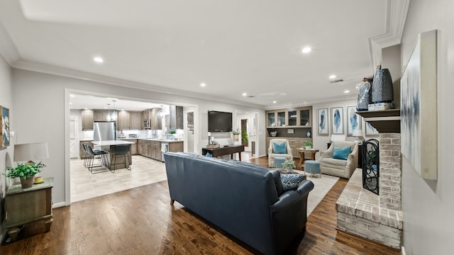 living room featuring wood-type flooring and crown molding