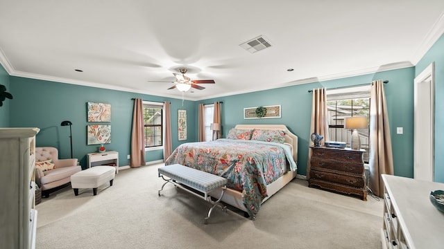 bedroom featuring ornamental molding, light colored carpet, and ceiling fan