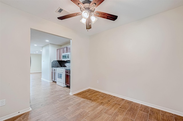 unfurnished room with ceiling fan and light wood-type flooring