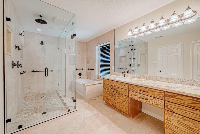 bathroom featuring vanity, shower with separate bathtub, and a textured ceiling