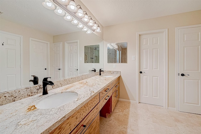 bathroom with vanity and a textured ceiling