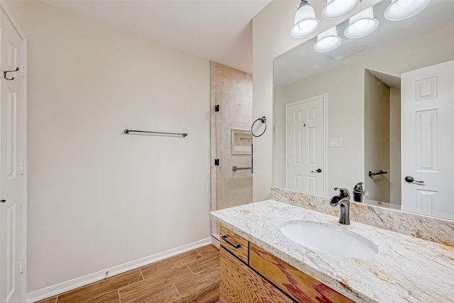 bathroom featuring vanity and a shower with door