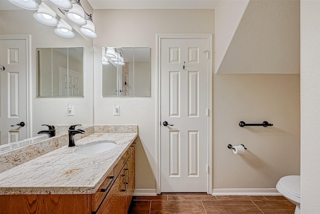 bathroom featuring hardwood / wood-style floors, vanity, and toilet