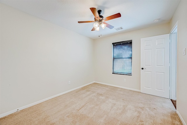 empty room featuring light carpet and ceiling fan