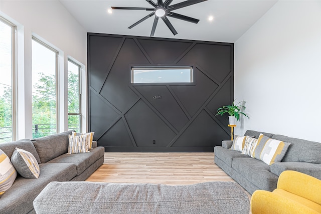 living room with light hardwood / wood-style floors and ceiling fan