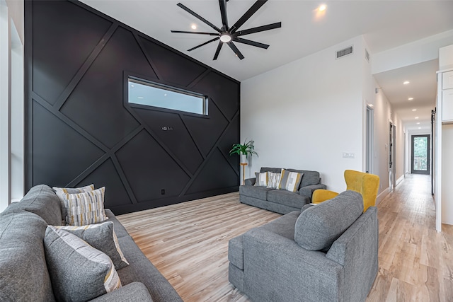 living room featuring light hardwood / wood-style floors and ceiling fan