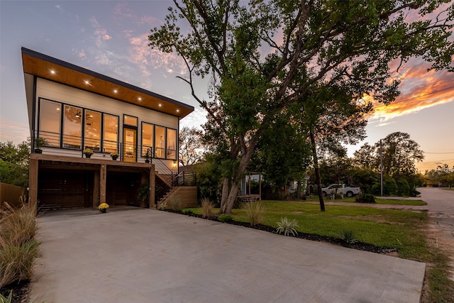 view of front of house with a garage and a yard