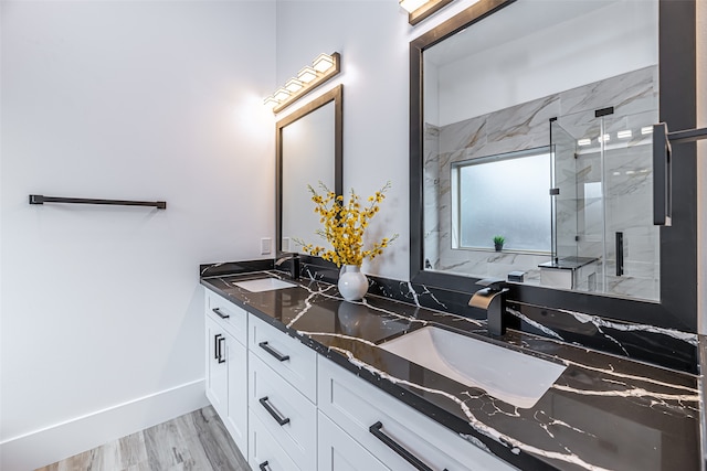 bathroom featuring vanity, hardwood / wood-style floors, and a shower with shower door