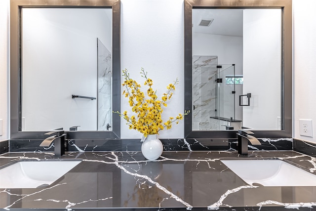 bathroom with vanity and a shower with door