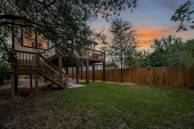 yard at dusk with a wooden deck