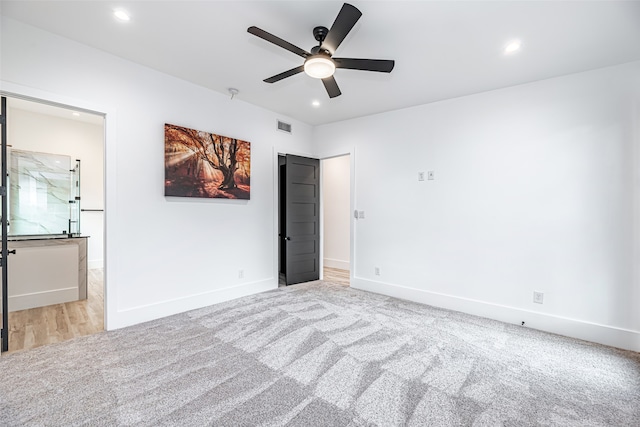 unfurnished bedroom with light colored carpet and ceiling fan