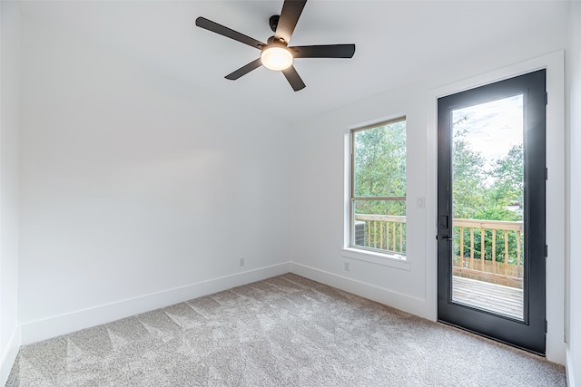 carpeted spare room with ceiling fan