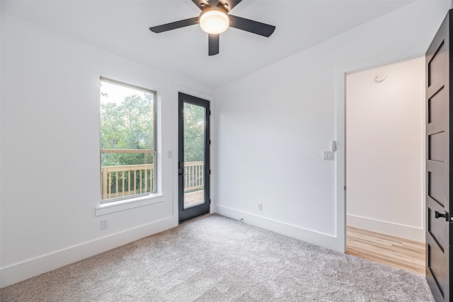 empty room featuring light colored carpet and ceiling fan