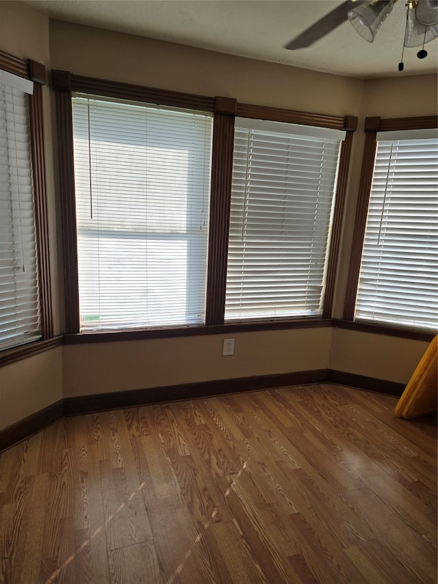 unfurnished room featuring hardwood / wood-style flooring and ceiling fan