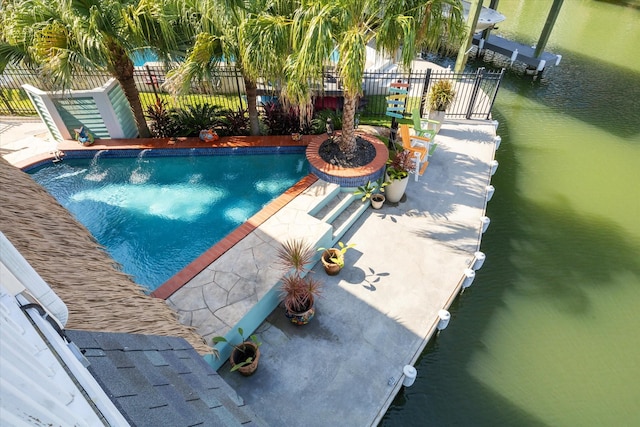 view of pool featuring a water view and a patio area