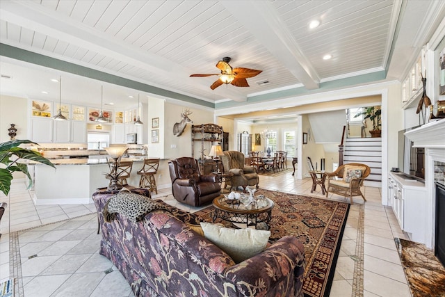 tiled living room featuring ceiling fan, beam ceiling, and wooden ceiling