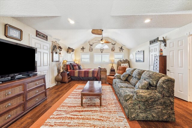 living room with ceiling fan, dark hardwood / wood-style floors, a textured ceiling, and lofted ceiling