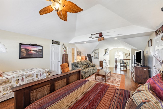 bedroom featuring hardwood / wood-style floors, vaulted ceiling, and ceiling fan