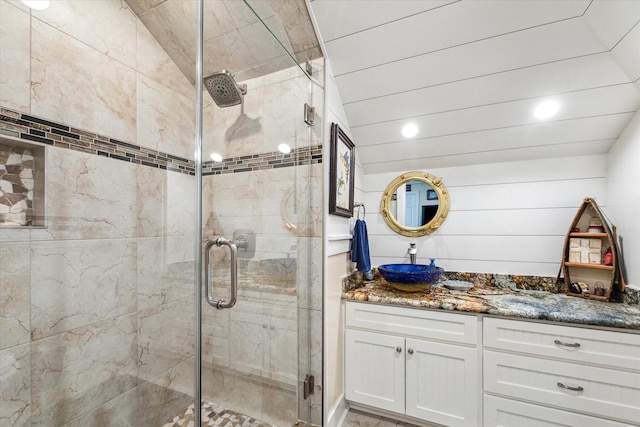 bathroom featuring vanity and an enclosed shower