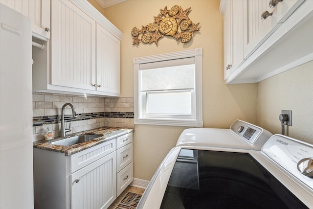 laundry area with cabinets, sink, and washer and clothes dryer