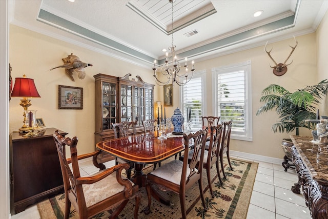 tiled dining area featuring an inviting chandelier, a tray ceiling, and crown molding