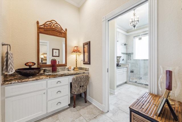 bathroom with crown molding, vanity, an inviting chandelier, and walk in shower