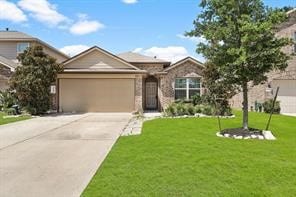 view of front of home with a garage and a front lawn